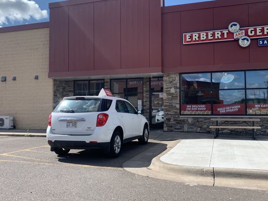 Delivery car illegally blocking wheelchair access to the store.