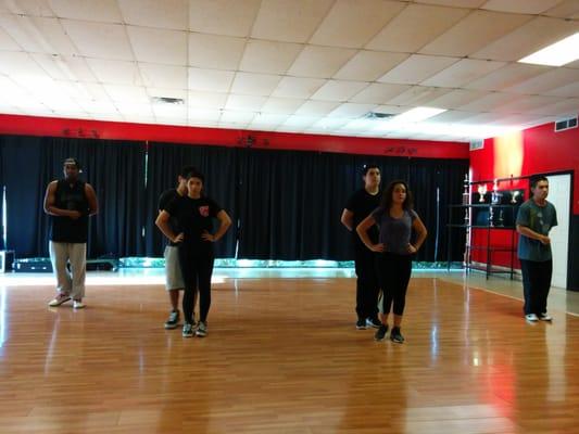 Krystal, one of Revolution's quince instructors going through steps with quince girl, Yesenia.