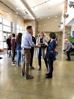 Church attendees visiting with Lead Pastor Michael Loudermilk in the lobby after service.