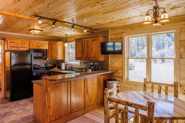 Open floor plan with a kitchen that is fully stocked with everything any discerning chef may need.