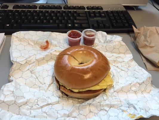 Bagel with cheese and sausage.