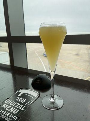 Enjoying a cocktail and watching the planes. They have phone charger hookup available.