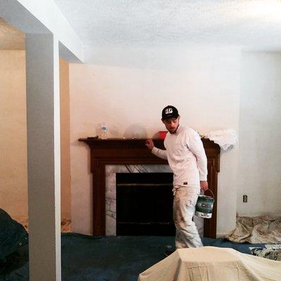 ExtraPrep Pro Painting Painter grabs a gallon of paint to begin painting a basement in Florence, KY.