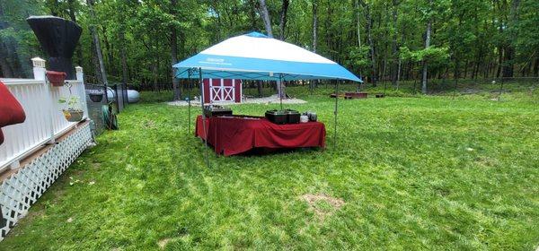 Serving tent and table being set up complete with ice trays to keep the salads cold and hot trays for the hot food!