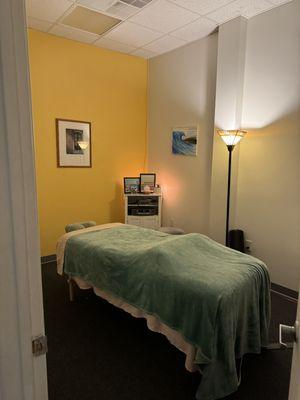 Single table massage room for a private and relaxing experience.