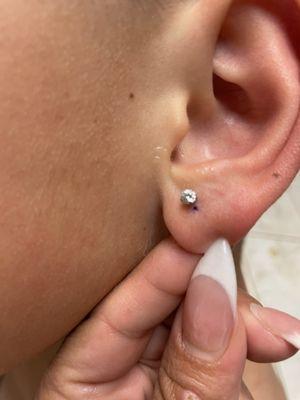 The second time she pierced the same ear she still missed the mark.