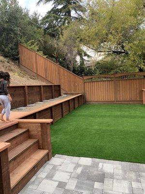 Retaining walls with new artificial grass and paver patio