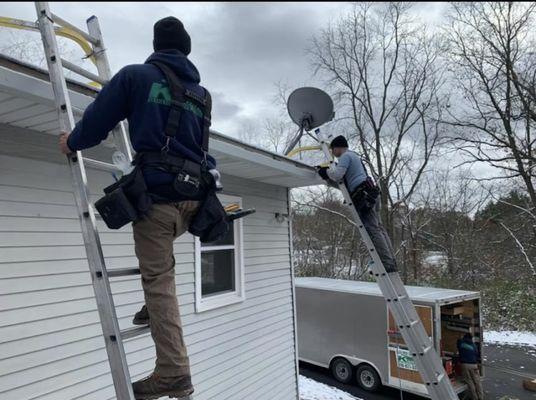 Gutters being measured for installation