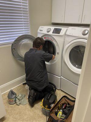 Dave is cleaning the washing machine gasket to sanitize it.