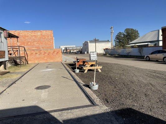 Tables & short steps up to the cool tasting room and pay phone