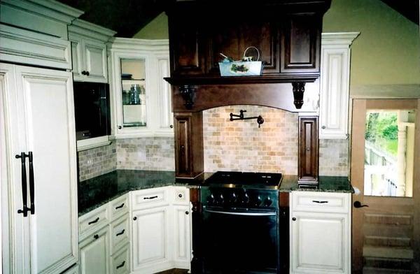 Kitchen with White Cabinets and Brick-style Backsplash