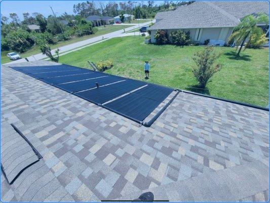 Aquatherm solar pool heating system on a shingle roof.