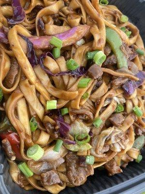 Chunky Chow Mein, marinated soy chunks, purple cabbage, bell peppers, low mein noodles garnished with green onions.