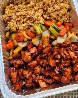 Triple teriyaki chicken tray with grilled vegetables and fried rice.