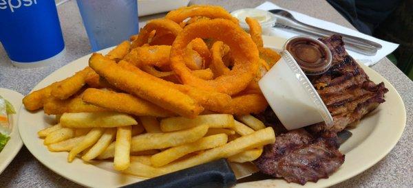 Tons of fries, zucchini, and onion rings covered my steak. The steak is larger than pictured and much more tender than I expected.