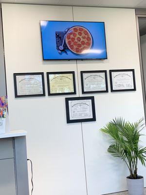 Tv and DVM licenses on display in waiting room