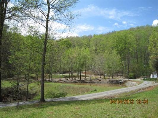 Road leading in to campground with pond in background