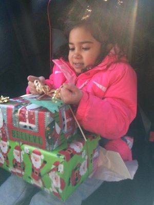 My daughter opening her gifts she got from the pre k