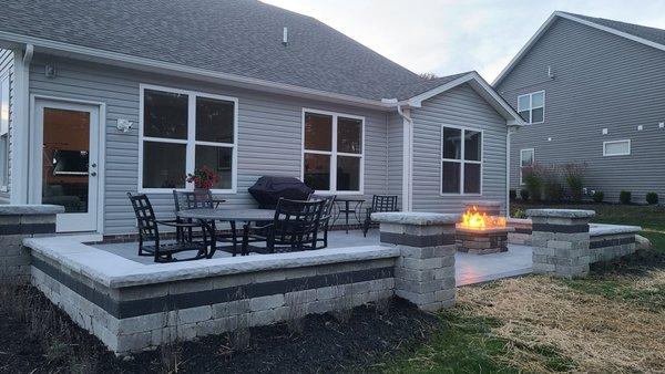 Stamped concrete patio w/ custom-made gas fire pit and seat walls.