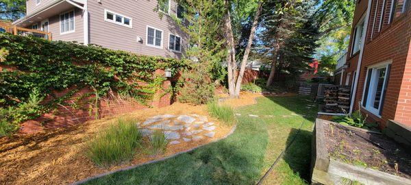 A beautiful gold colored mulch was used to upgrade this backyard.