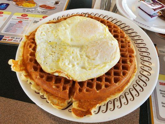 Waffle and fried eggs on top