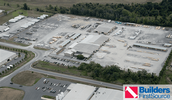 Building materials supplier Builders FirstSource's forklift is moving wood roof trusses.