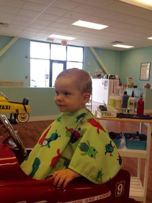 Sitting in a firetruck chair for the haircut.