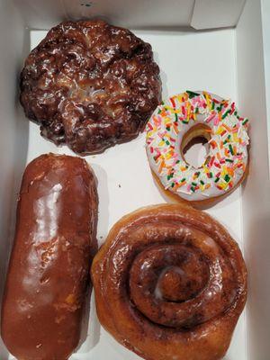 Apple fritter, vanilla frosted raised, cinnamon roll, Bavarian cream filled donuts