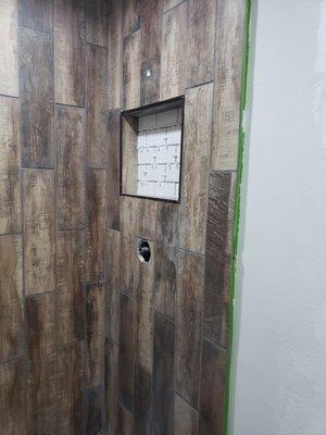 Shower with plank flooring ceramic tile for a great look