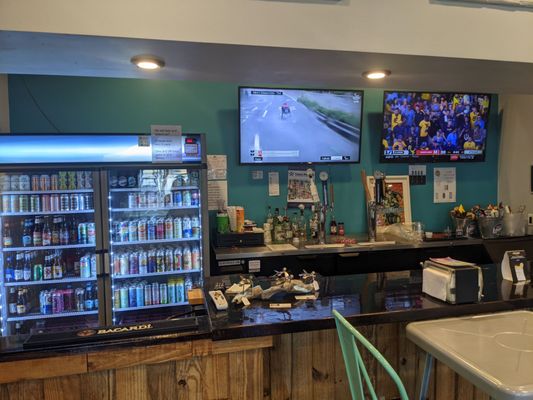 Taps, beer cooler, and tvs in indoor dining area