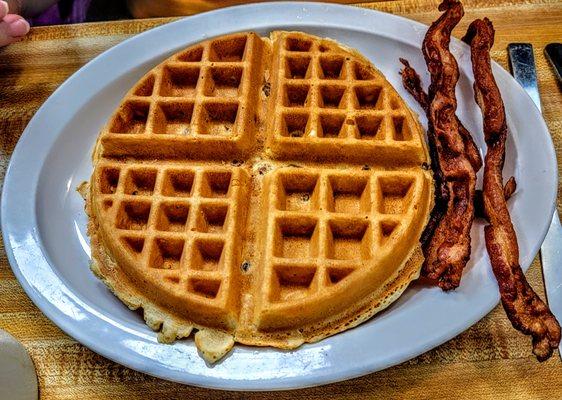 Waffle with Pecans and a side of crispy bacon.