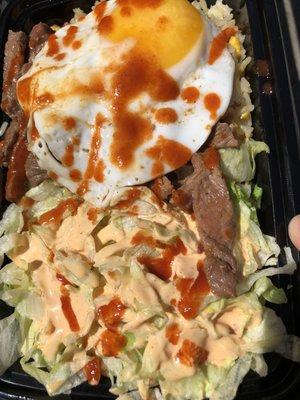 Steak combo ( comes with garlic fried rice and salad). I added a fried egg and squirted a. Inch of Sriracha sauce.