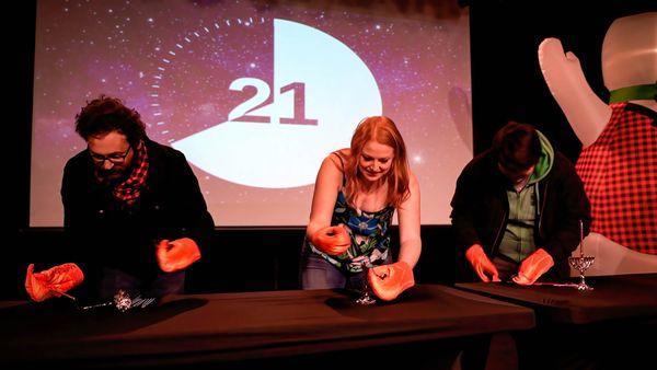 Contestants compete in a goofy physical challenge in 100 League's holiday show Elf Rebellion at The Showbox in Seattle.