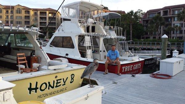 Captain Jeff and our marina buddy Stretch the blue heron at the dock.