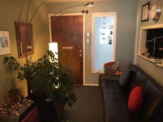 Sitting area in entryway. Plants, fountain and comfy couch... Relax!