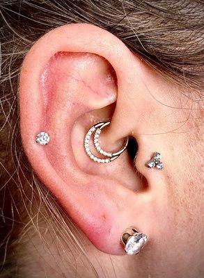 Helix w/ Titanium Prong.  Daith w/ CZ Double Clicker. Tragus with CZ Trinity Prong set.