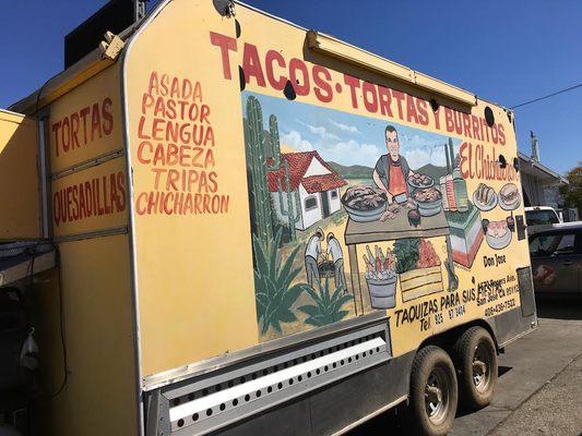 Side of the food truck. Does that car have a Ghostbusters decal on the door? WTH?