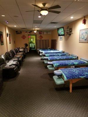 Long view of the massage tables & Reflexology recliners.