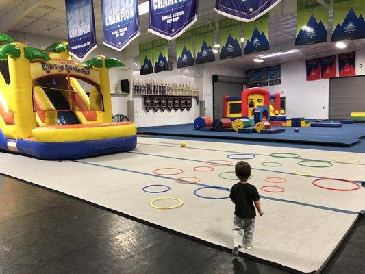 Two bounce houses, long trampoline, low balance beam, and some soft play things to climb