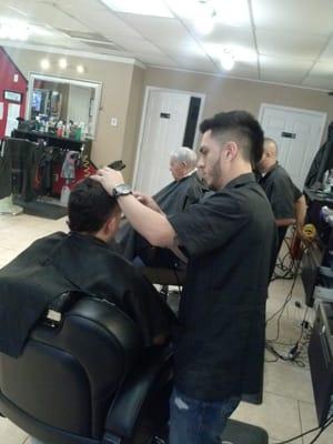 Felipe working on one of his signature mohawks