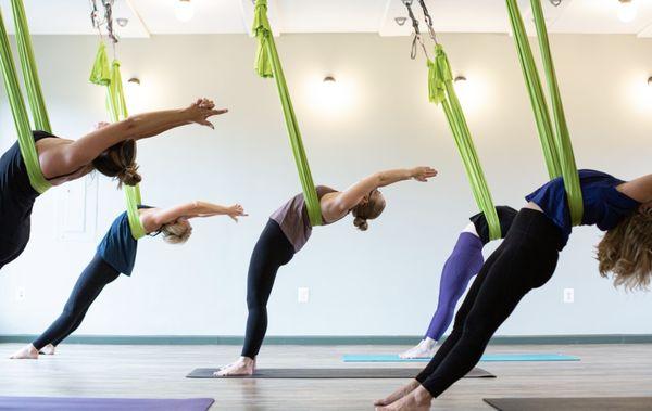 Open tight shoulders and release your tension with aerial yoga backbends.