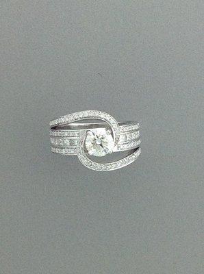 Wide 14 karat white gold diamond band featuring round and square cut diamonds and large center diamond