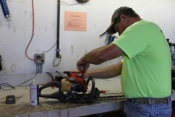 Repairing a chain saw in out Chambersburg garage