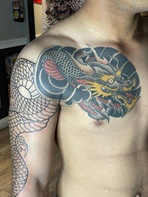 Healed Japanese dragon chest piece and fresh line work for continued sleeve.