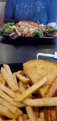 Grilled club sandwich and a salmon salad in the background July 2 2021