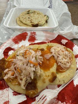 Pupusa calabasa and pupusa Chicharron con Queso topped with sauce and curtido. (12/27/2023)