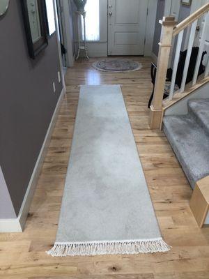 Existing round Oriental area rug in front of entry door.