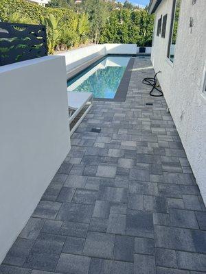 Swimming pool, coping, and pay and install with smooth, stucco partition, and retaining wall