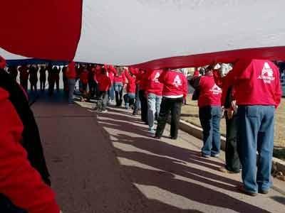 Advantage Bankers help carry the huge US flag in the annual MWC Veterans Day Parade.