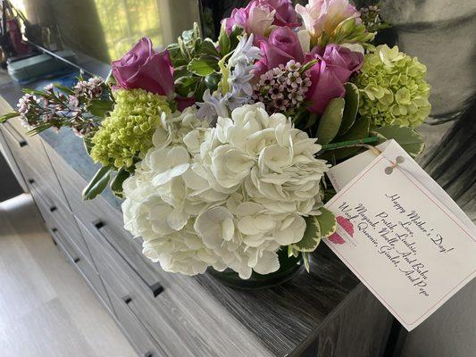 Floral bouquet of white, green, pink, and purple flowers